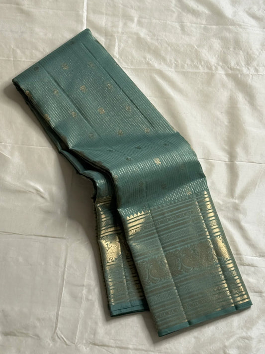 Muted sea-jade/duck-egg green body with fine oosi (pin) stripes

All-over tiny rosette/coin buttas for a soft shimmer

Silk Mark Certified | Free Shipping within USA | Ships in Two Weeks. Blouse Stitching ($30)