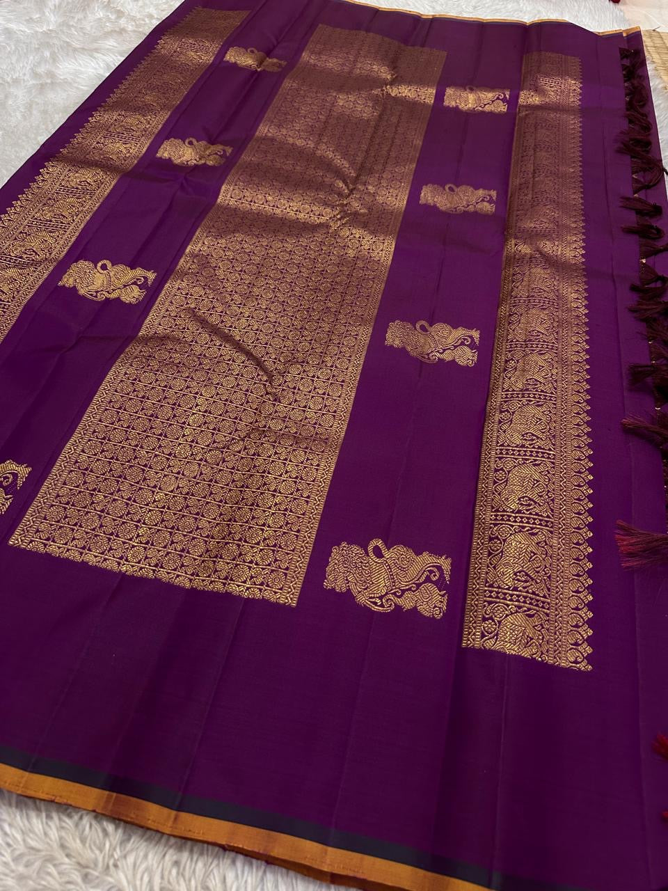 Lavanya– radiant purple Handwoven Kanchipuram Silk Saree in purple with Gold & Silver Zari, this deep purple Kanchipuram silk saree with intricate motifs in gold and silver zari, including Gandaberunda, parrots, elephants &lotuses as seen on Nita Ambani