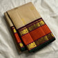 Pure Kanchipuram silk saree folded in biscuit beige with small gold buttas and rust orange zari woven border, maroon striping, and green edge
