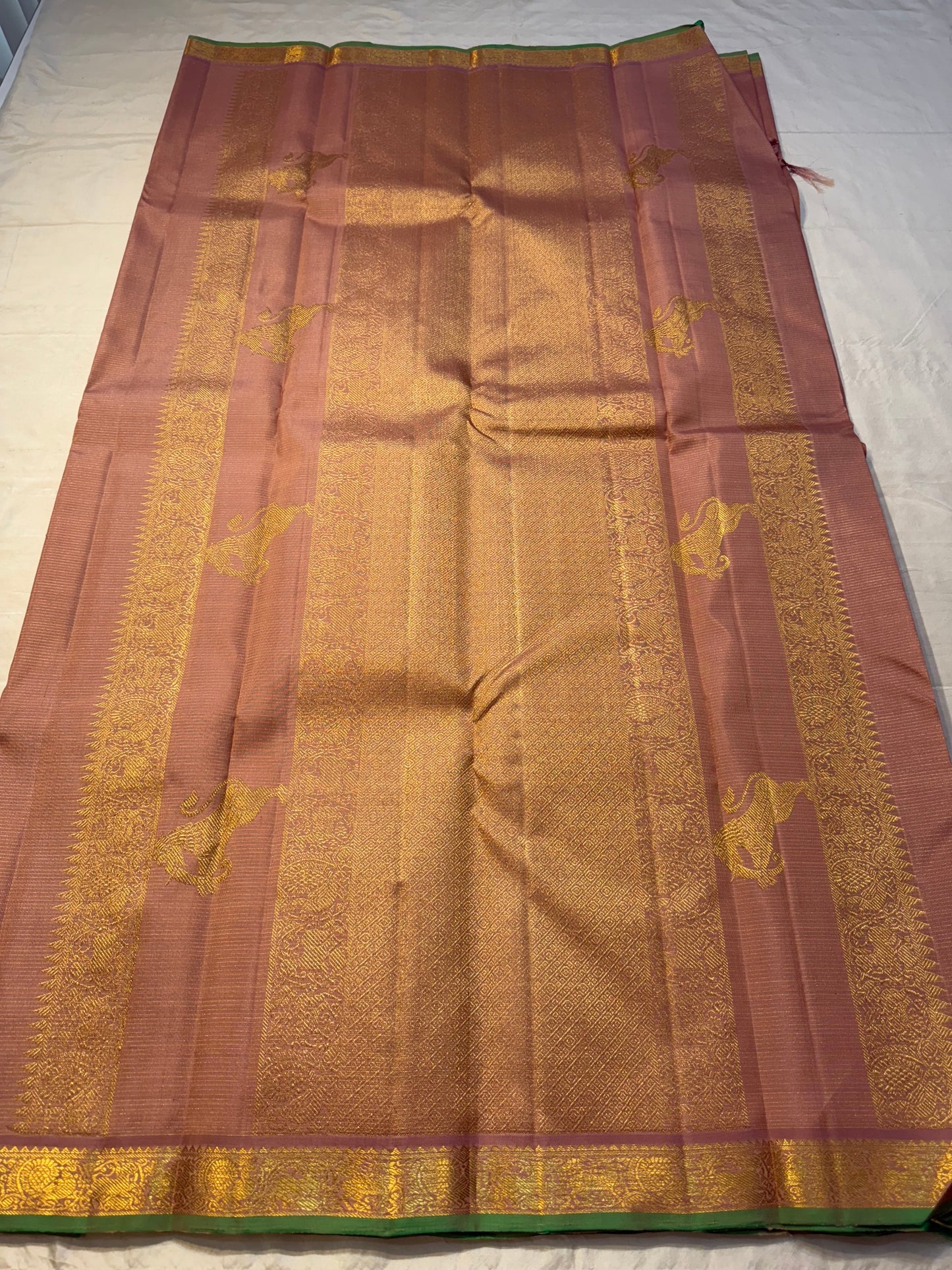 Tamra Yazhi — Pure Kanchipuram Silk vairaoosi with Antique Gold zari  Yazhi Motifs
green-edged traditional brocade border
Silk Mark Certified • Free Shipping within USA • Ships in Two Weeks
