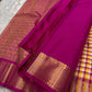 A classic Kanchipuram in Pattani Kattam checks with pink, magenta, mustard, and cream.
Finished with a contrast pink border and pallu.
Paisley and chakram motifs in a graceful grid add timeless charm.