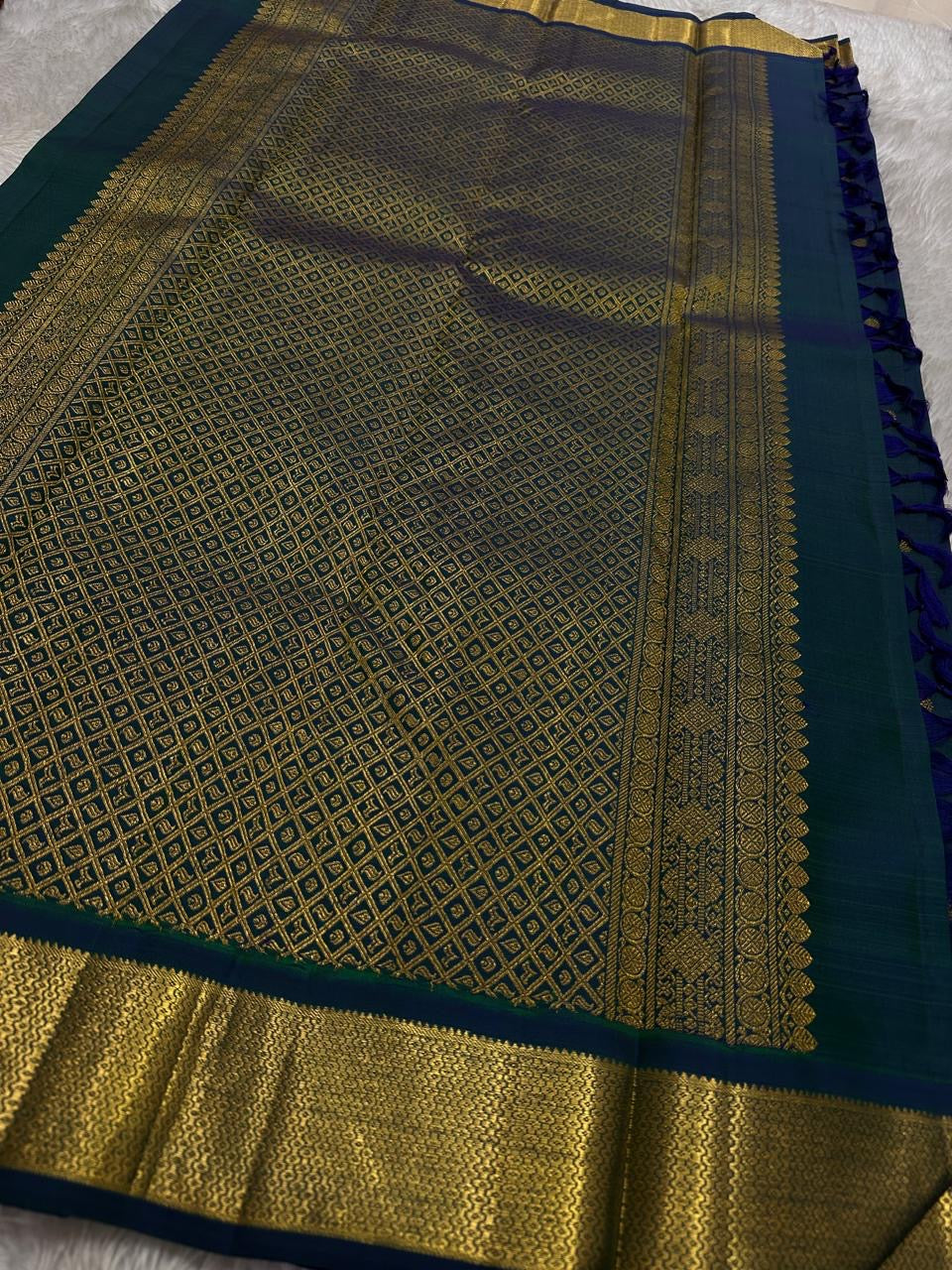 Detailed pallu view with dense diamond jaal zari weaving, temple-inspired edge and antique-gold zari border