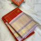 Bhargavi
Striking Orange Kanchipuram Silk Saree with Unusual Lavender Border 💜
Zari Kattam Neli Checks with Kamalam & Mayil Motifs Across the Body 🪷🦚
Broad Arai Maadam Border Flanked by Diamond & Paisley Motifs, Grand Zari Pallu ✨