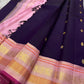Shyamala—named after the deep, dark shade it embodies 💜 A pure Kanchipuram silk masterpiece with a rich purple body sprinkled with golden zari buttas. The contrast pink border glows with floral and paisley zari motifs, accented in coral and rose-gold, wh