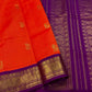 An exquisite blend of tradition and vibrancy, this silk cotton saree features a radiant orange body adorned with elegant gold zari buttas, The rich contrast border and pallu in royal purple and intricately woven with traditional gold zari motif