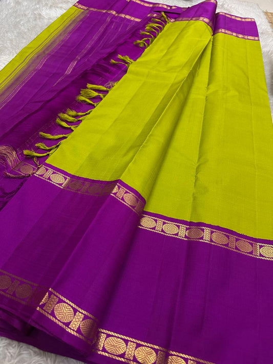 Purple Kanchipuram silk saree body with vertical gold zari lines and circular zari border detailing