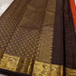 Mantra – Rust brown with coffee brown Kanchipuram Silk Saree with zari Checks with small buttas all over and Antique Peacock zari Border  showcasing regal peacocks and floral vines. A richly detailed pallu completes this heritage Zari kattam
