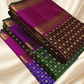 An heirloom-worthy drape woven in the finest 2G pure silk, this traditional Kanchipuram saree brings together the timeless beauty of zari buttas and checks in a rich green body. The contrast purple  rettapet border stands bold and elegant
