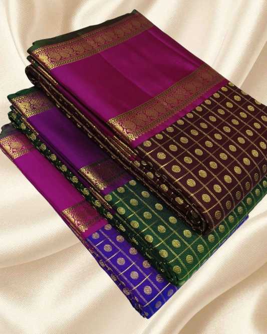 An heirloom-worthy drape woven in the finest 2G pure silk, this traditional Kanchipuram saree brings together the timeless beauty of zari buttas and checks in a rich green body. The contrast purple  rettapet border stands bold and elegant