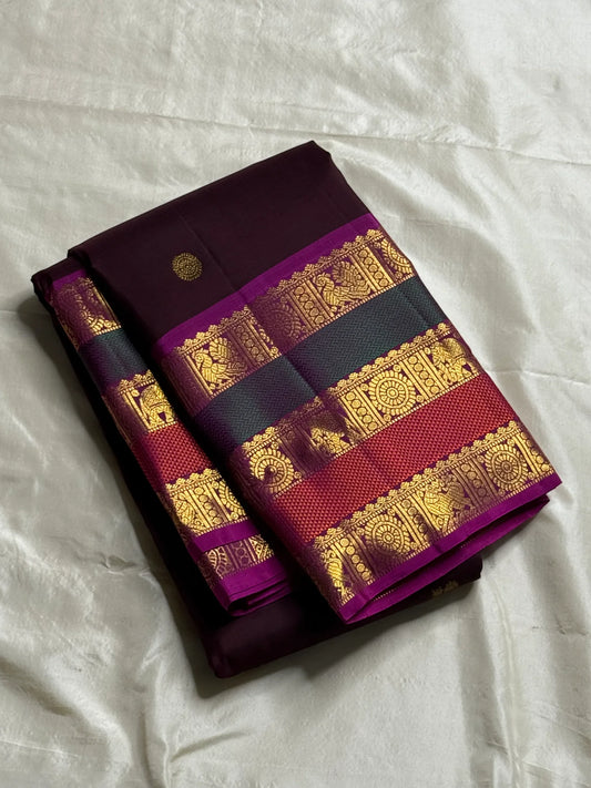 Coffee Brown Rajam – Pure Kanchipuram Silk Saree
Coffee Brown Body with Gold Zari Buttas
Rani Pink Korvai Borders with Temple, Peacock & Elephant Motifs
Grand Rani Pink Zari Brocade Pallu with Vertical Stripes & Tassels
Silk Mark | ships in two weeks