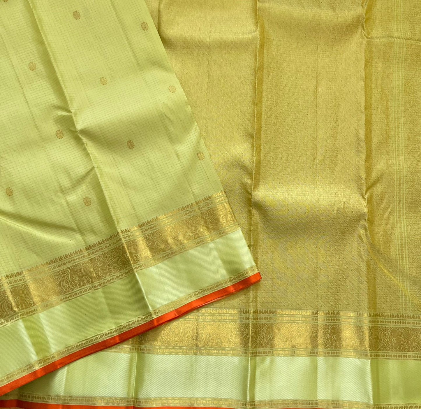 Meadow Shine — Kanchipuram Pure Silk Saree

Pastel meadow-green body with micro kattam checks & zari buttas

Antique zari borders woven with vine & elephant motifs

Warm kesari-orange selvedge a radiant edge . Silk mark cert￼. Free shipping within USA