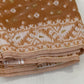 Jamdani weave close-up with delicate ivory floral buttas on biscuit-brown base