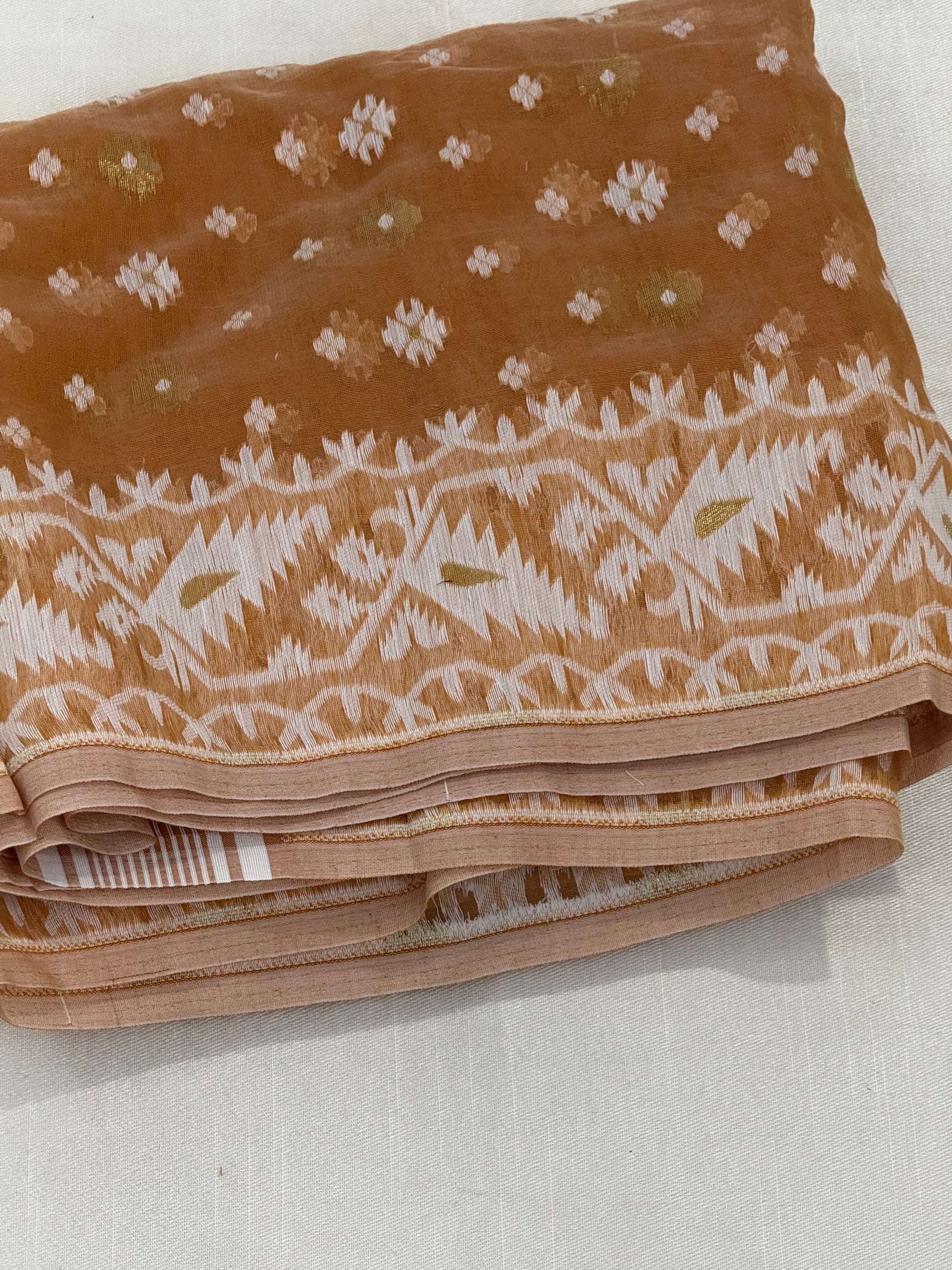 Jamdani weave close-up with delicate ivory floral buttas on biscuit-brown base