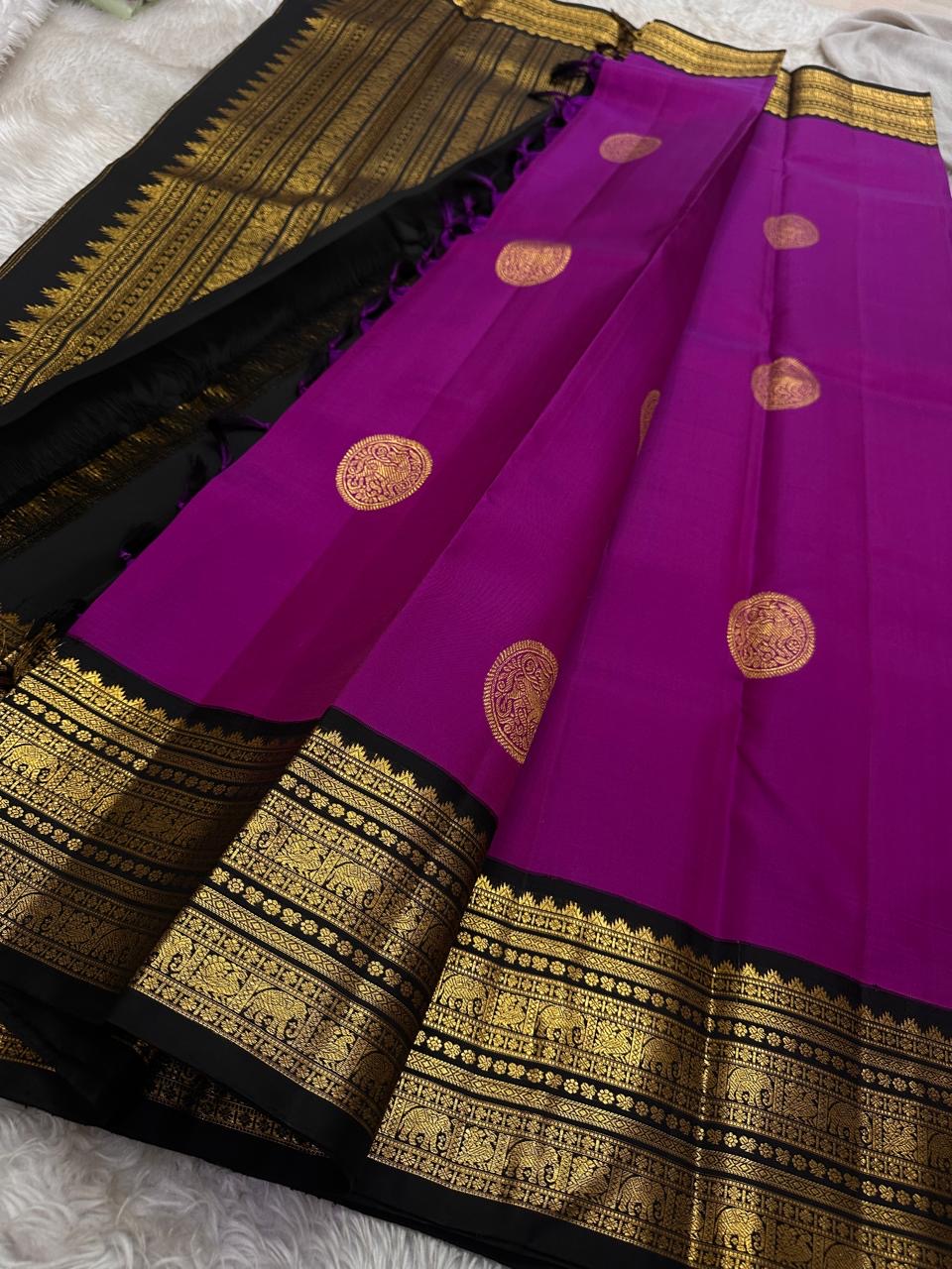 Menaka ✨ Draped in vibrant purple , its body shines with golden Yazhi motifs enshrined in Sorgavaasal arches. The contrasting black Korvai border, alive with elephants, vines, and temple motifs in zari and lavish Pallu , silk mark certified ❤️