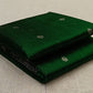 folded green chanderi silk saree with small woven motifs visible