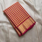 A classic Kanchipuram in Pattani Kattam checks with pink, magenta, mustard, and cream.
Finished with a contrast pink border and pallu.
Paisley and chakram motifs in a graceful grid add timeless charm.