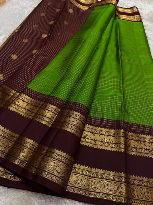 Pure silk kanchipuram with a green zari kattam and a deep coffee brown border rettapet vanasringaram border
