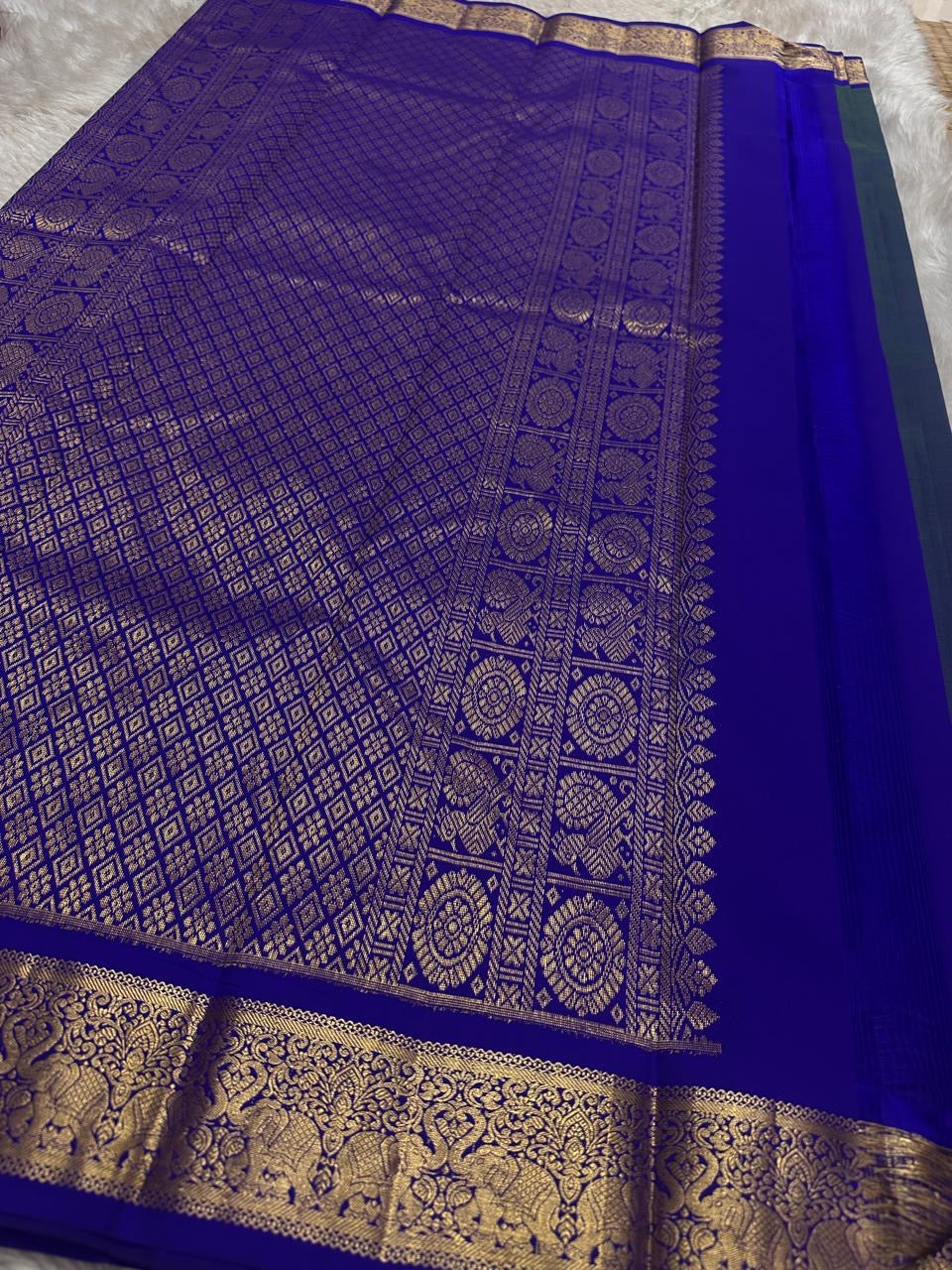 Swaram Lightweight – Peacock Dusk Blue
Feather-Light Peacock Blue Kanchipuram Silk Saree
Elephant & Tree of Life Zari-Woven Grandeur