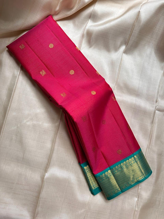 A Very unusual raspberry pink and teal vairaoosi pure silk Kanchipuram Mayil and coin zari buttas all over the boat on top of the zari stripes ! Detailed mayil paisley chakram grid pattern on Pallu 💕