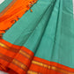 Sharvani blue sea green – sea green  Checked Silk Saree with an Orange red  shot color Zari Border & Vibrant Pallu A timeless silk saree featuring a cream body with delicate red checks, complemented by a striking churan orange  zari border pallu.