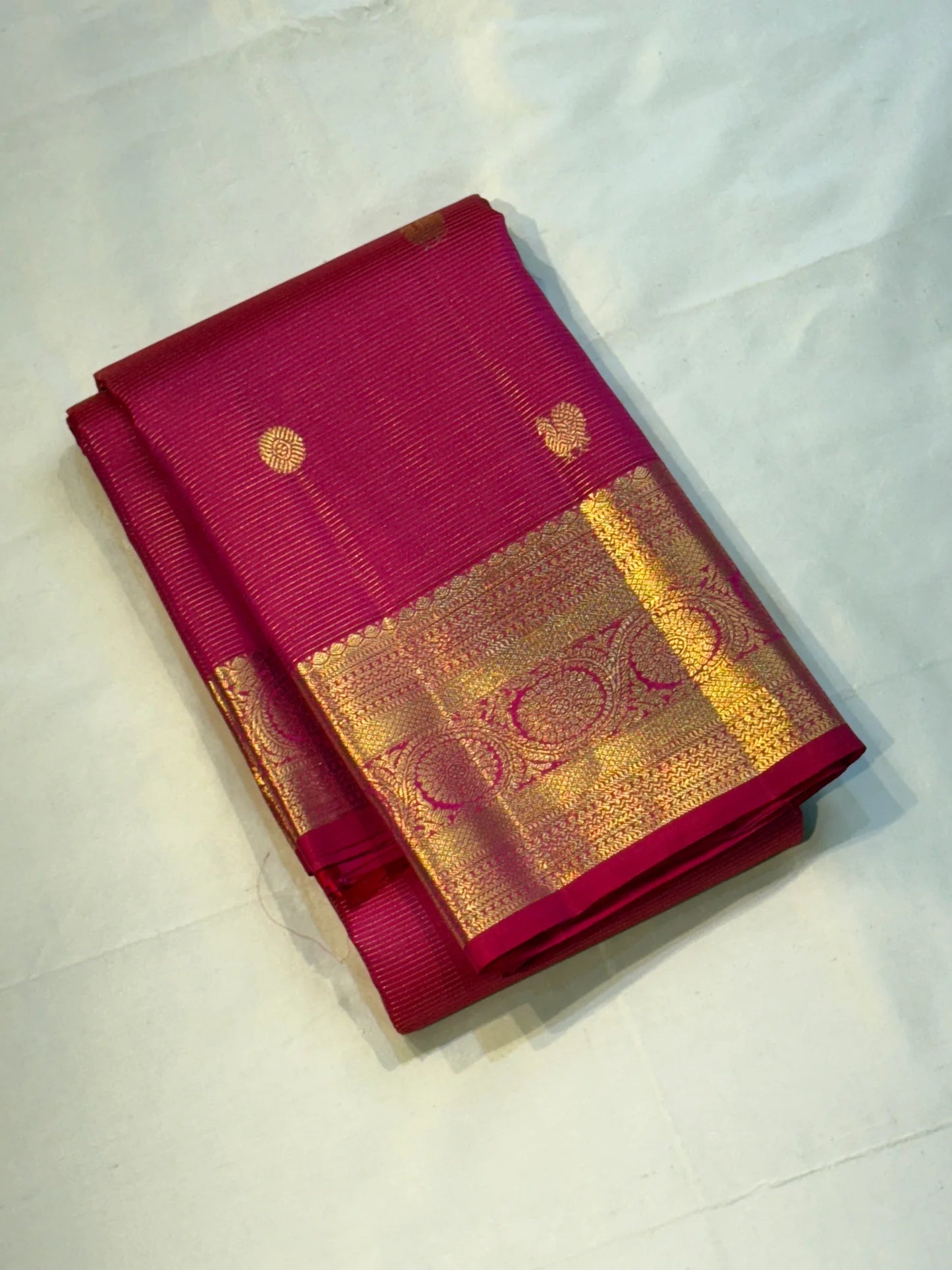 Nakshatra – Radiant pink Vairaoosi Kanchipuram Silk Saree Adorned with Mayil & Chakram Zari Buttas, Featuring an Ornate Kamalam and Floral Vine Zari Border, Flanked by Varisaipet Motifs, and a Pallu Woven with Sacred Thulasi Madams and Regal Kamalams