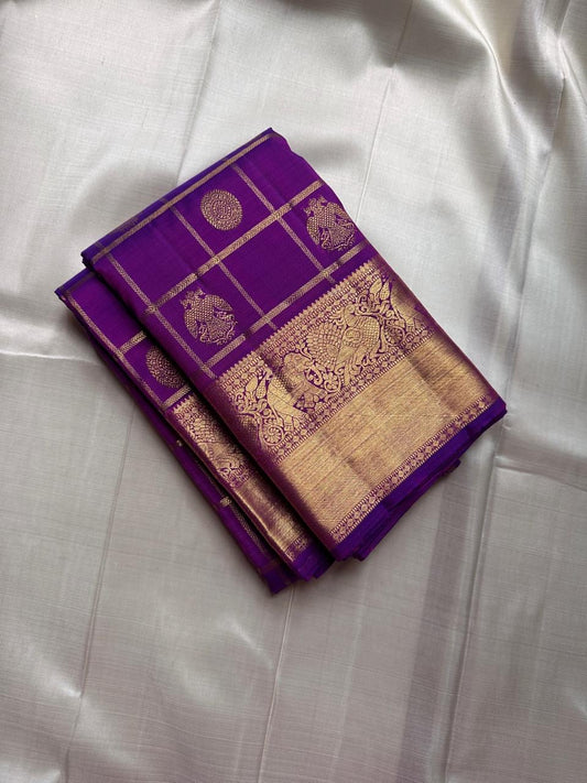 Amethyst Gandaberunda Kamalam – Pure Kanchipuram Silk Saree

Amethyst Purple Body with Zari Kattam Checks & Lotus Buttas

Grand Antique-Gold Borders with Gandaberunda & Peacock Motifs

Purple Zari Brocade Pallu

Silk Mark , ships in 2 weeks