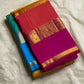 Varna Jaalam — Kanchipuram Pure Silk

Manjal yellow body with gold chakram buttas

Rani pink korvai border with floral & coin zari panels

Magenta–orange chevron pallu with blue–green color block top

Silk Mark Certified • Free Shipping within USA •