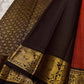 Mantra – Rust brown with coffee brown Kanchipuram Silk Saree with zari Checks with small buttas all over and Antique Peacock zari Border  showcasing regal peacocks and floral vines. A richly detailed pallu completes this heritage Zari kattam