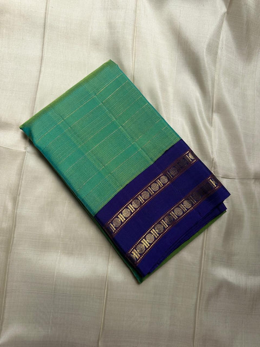 Madhurima – Handwoven Peacock Green Pure Kanchipuram Silk Saree with All-Over Zari Stripes, Contrasting Royal Ink Blue Rettapet Border & Matching Blouse Fabric (Silk Mark Certified)