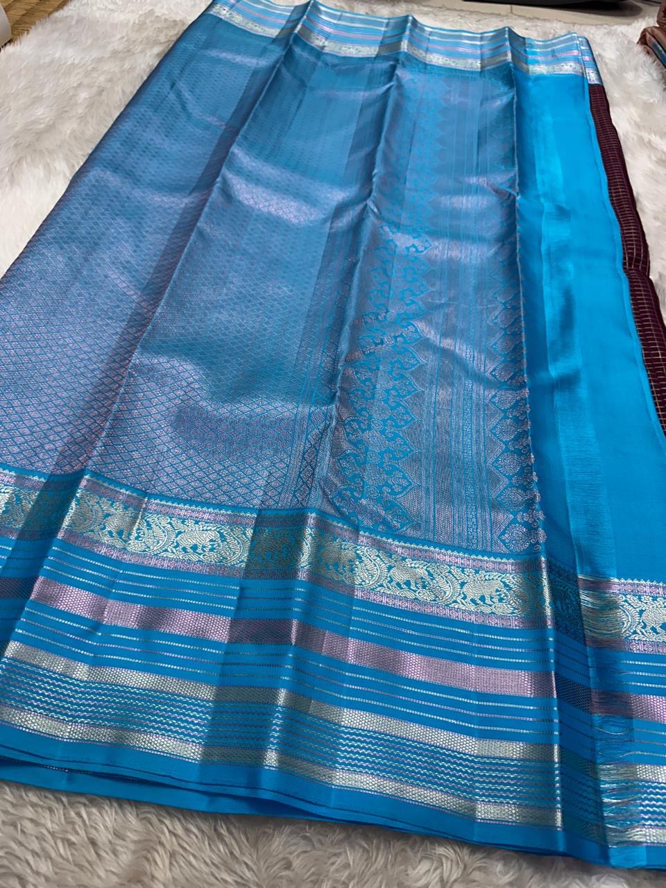 Most unique brown and blue combination in pure silk Kanchipuram with Zari kattam and elephant motif border