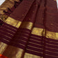 Open view of maroon Kanchipuram silk saree with tasselled pallu, horizontal zari lines and intricate gold yali–elephant borders.