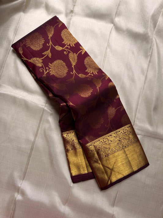 Tanvi – Coffee Brown Kanchipuram Pure Silk Saree with Floral Zari Jaal & Baavanji Border

Rich coffee brown silk adorned with delicate floral zari jaal creates a timeless elegance.
The bold Baavanji border and grand Varisaipettu pallu