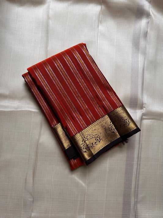 Tamra — Rust Vairaoosi Kanchipuram Pure Silk

 

Coffee Brown Korvai Border & zAri Pallu

 

elephant motifs  Medallions & Annam Panels in Gold Zari

 



Silk Mark Certified | Free Shipping within USA

 

Ships in Two Weeks | Blouse Stitching $30