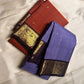 Classic heritage finesse in this lilac blue pure Kanchipuram silk saree Zari kattam , intricately handwoven with fine golden checks across the body. Scattered floral buttas add delicate charm,rich purple peacock border