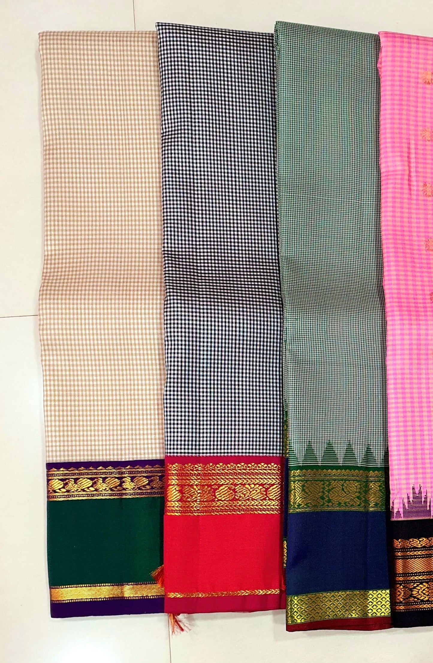 Podi Kattam Emerald Pillar Moggu – Pure Kanchipuram Silk Saree
Seafoam–Ice Blue Micro Checks with Korvai Emerald Green Border
Neelam Blue Panel & Gold Zari pillayar Moggu Motifs
Rich Emerald Zari-Striped Pallu | silk mark certified Saree ships in two week