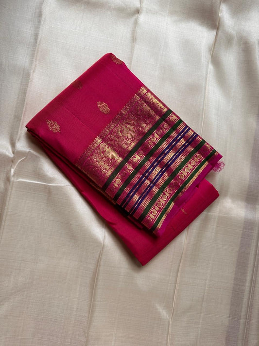 Kaamini ✨ — Fuschia Pure Kanchipuram Silk Saree
With Scattered Gold Zari Buttas on Lustrous Body
Bold Striped Korvai Border in Green & Blue Accents
Grand Fuschia Pallu Woven in Intricate Gold Zari
Contrast Blouse with Matching Zari Border Finish