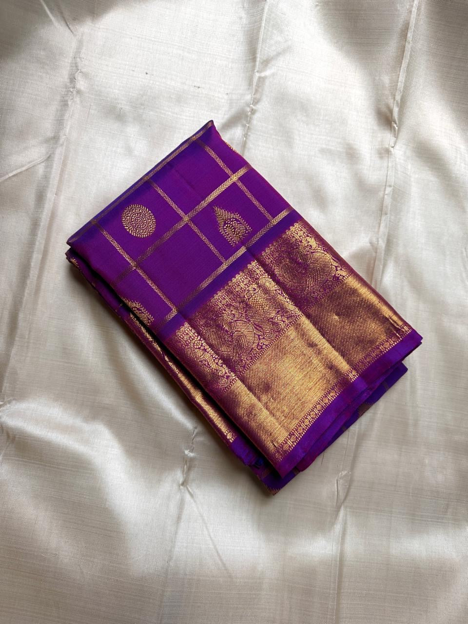 Leelavati Kattam
Amethyst Purple Kanchipuram Silk Saree
Zari-Woven Checks with Elephant Procession Border