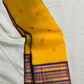 Swarna Kanakam Mayil Chakram — Pure Kanchipuram Silk Saree
Radiant turmeric-gold body adorned with silk-thread mayil and chakram buttas, framed by a regal vadamalli zari-woven korvai border and rich purple pallu.
Silk Mark Certified • Blouse Stitching Ava