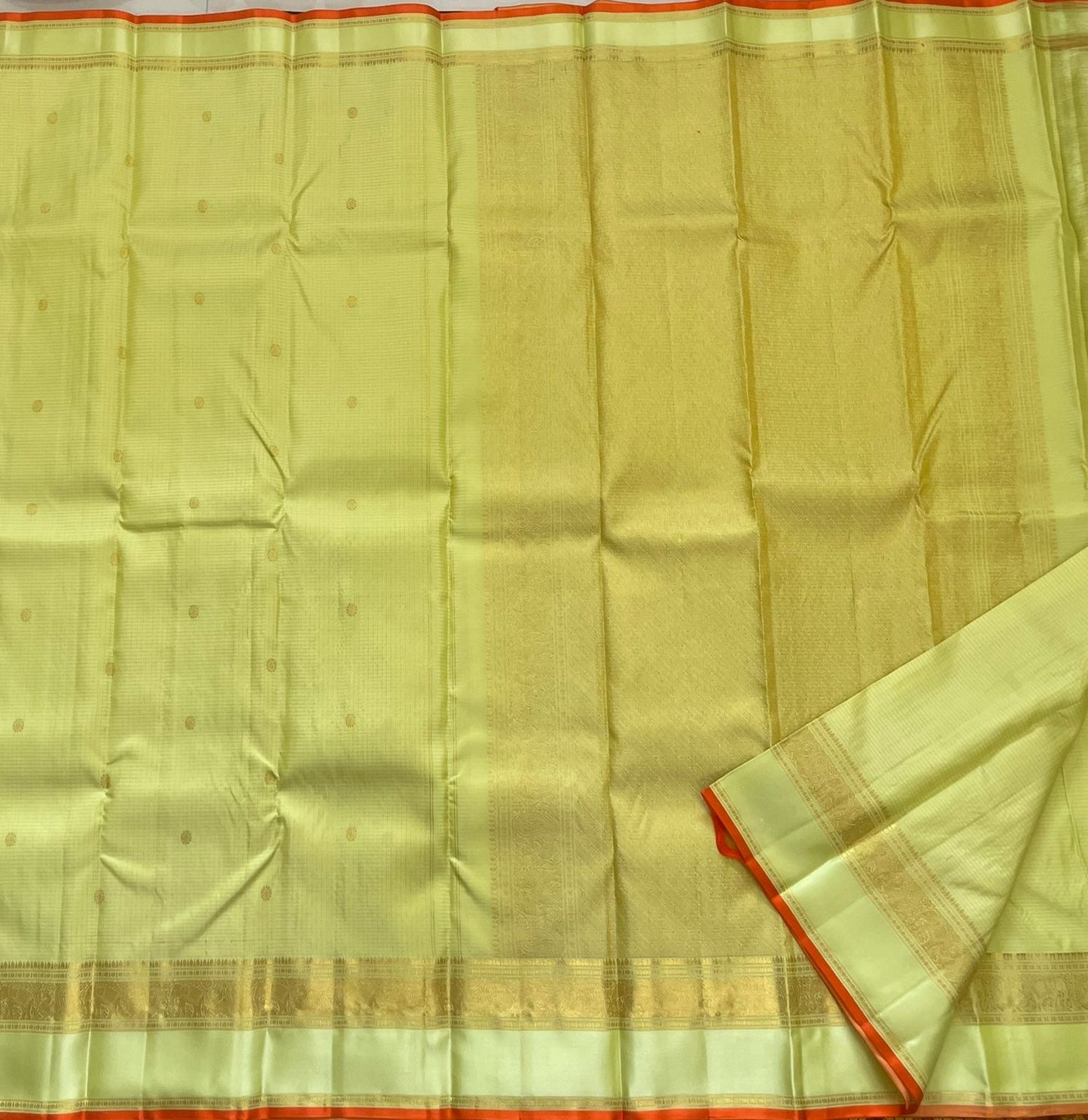 Meadow Shine — Kanchipuram Pure Silk Saree

Pastel meadow-green body with micro kattam checks & zari buttas

Antique zari borders woven with vine & elephant motifs

Warm kesari-orange selvedge a radiant edge . Silk mark cert￼. Free shipping within USA