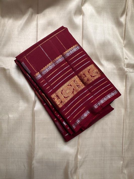Pankajam 🌺 – Brown maroon Kanchipuram Silk Saree with Zari Kattam, Dashed Lines, Kolam Motifs, Varisaipet Border with Thandavalam Zari Stripes, Rudrakshpet, Annam & Kamalam Motifs, Deep Brown Selvedge & Ornate Pallu