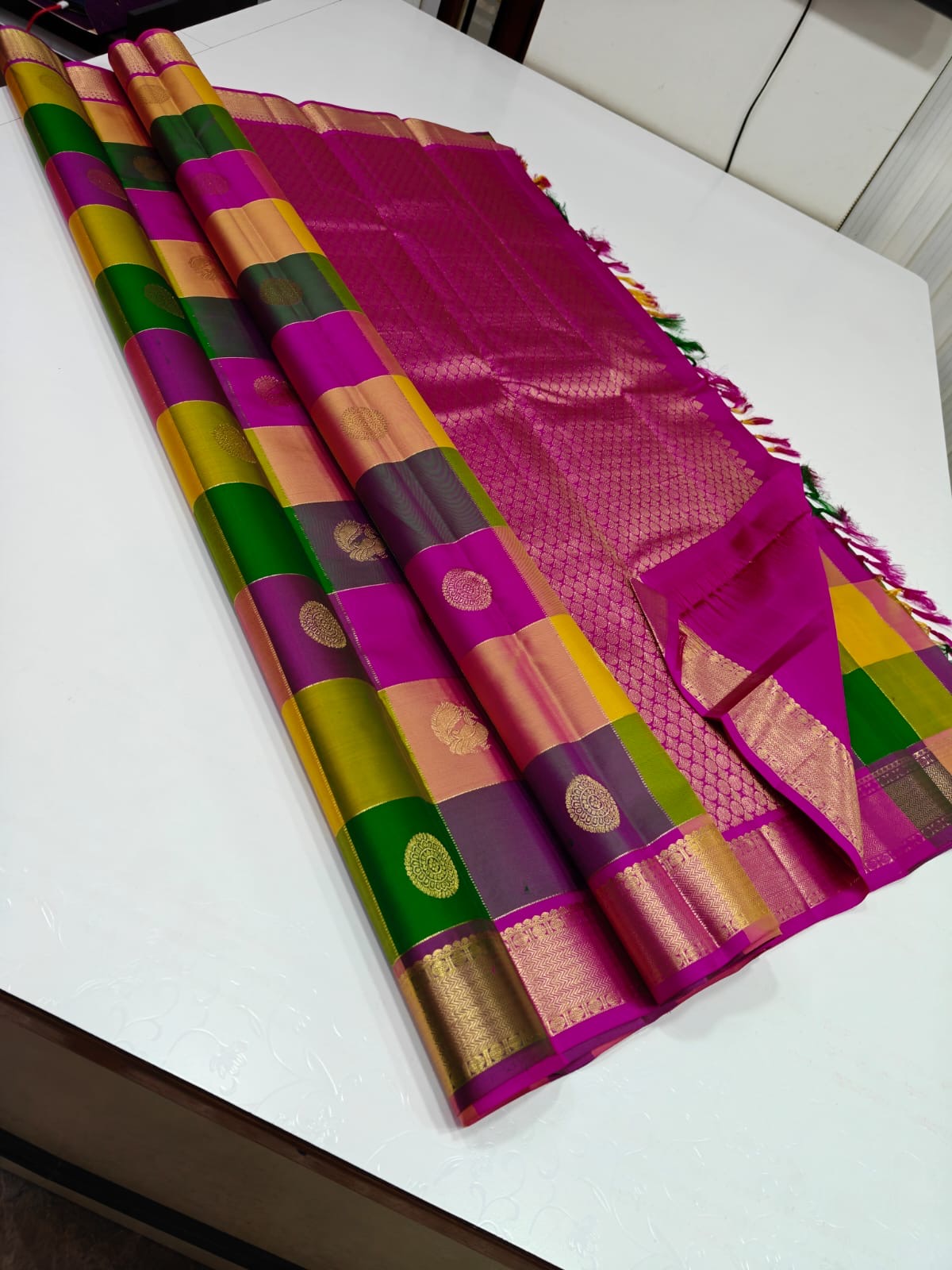 Navaratnam Paalum Palamum ✨ – Pure Kanchipuram Silk Saree
Multi-Color Kattam with Zari Mandala Buttas
Rani Magenta Korvai Border & Grand Zari Brocade Pallu
Contrast Rani Magenta Blouse with Matching Zari Border
Silk Mark Certified ✅ | Ships in 2 weeks