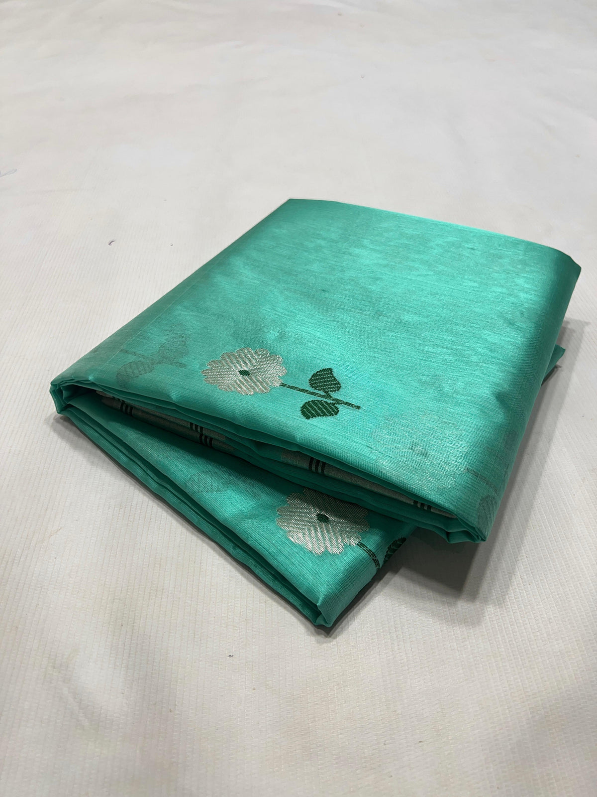Aqua Turquoise Handloom Pattu Silk Chanderi Saree with silver floral buttas and deep green accents