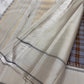 Nirai – Pure Kanchipuram Silk in Sandal, Grey & Mauve Checks.
Framed with a subtle sandal border and navy thread stripes, the saree features a striking pallu woven with thazhampoo reku and beautiful mullai mottu motifs in navy silk thread