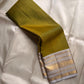 Luminous Lemon-Olive Green — White Korvai Kanchipuram

Pure Silk | Vairaoosi Checks | Korvai Contrast Borders

Classic White & Gold Pallu with Coin Jaal Motifs

Perfect for Muhurtham, Haldi & Temple Occasions

Silk Mark Certified | Free Shipping | Shi