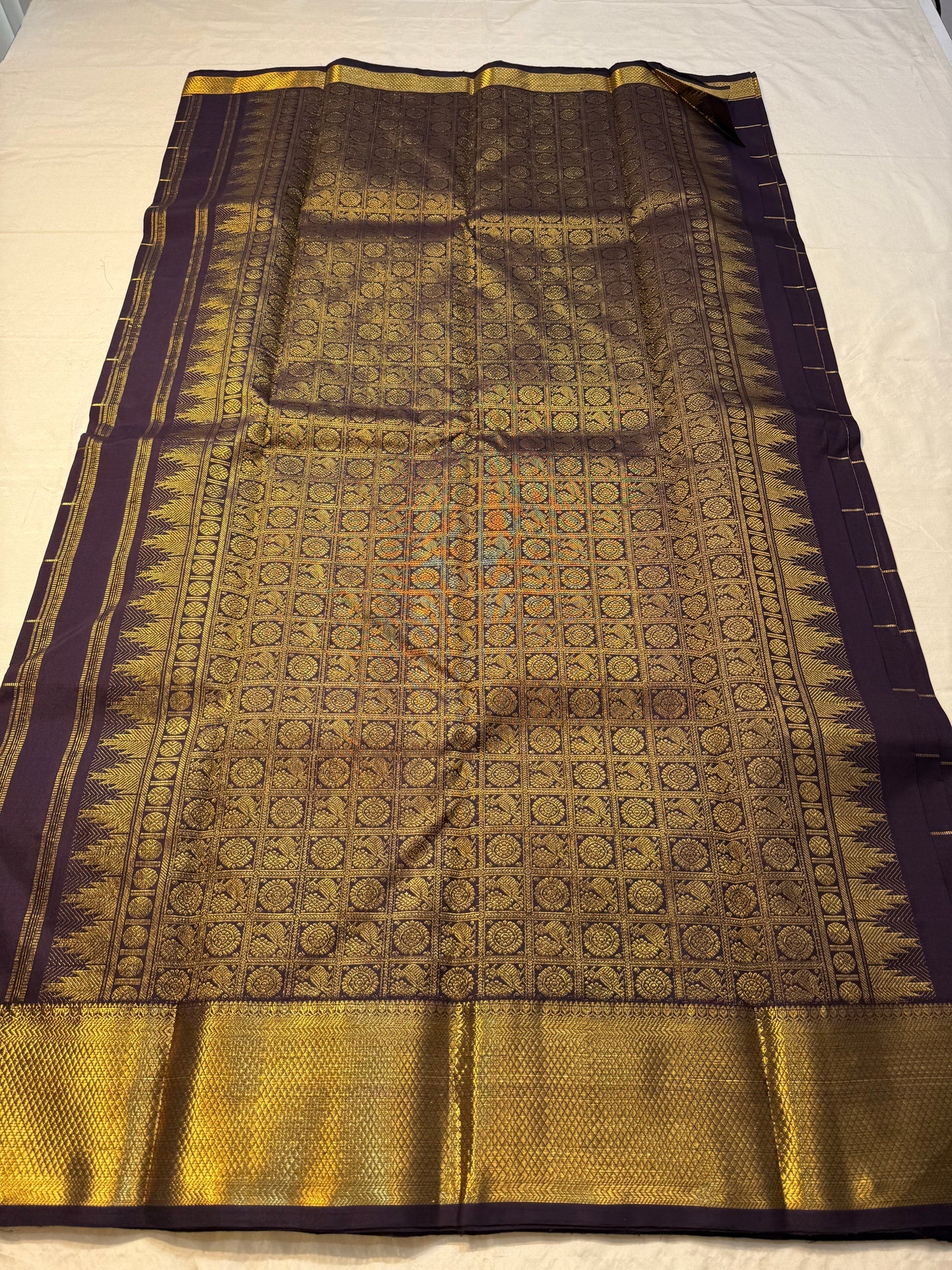 Plum Zari Kattam — Pure Kanchipuram Silk Saree
Rich plum body with gold kattam grid & Gandaberunda buttas ✨
Antique-gold brocade border & grand zari pallu • Silk Mark Certified • Free Shipping within USA • Ships in Two Weeks