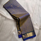 Varnam – Dove Tail Gray & Peacock Blue Kanchipuram Silk Saree. Featuring rich gold paisley buttas, a bold chevron zari border, and pure handloom silk craftsmanship ✨ Silk Mark Certified | Blouse Stitching Available | Free USA Shipping