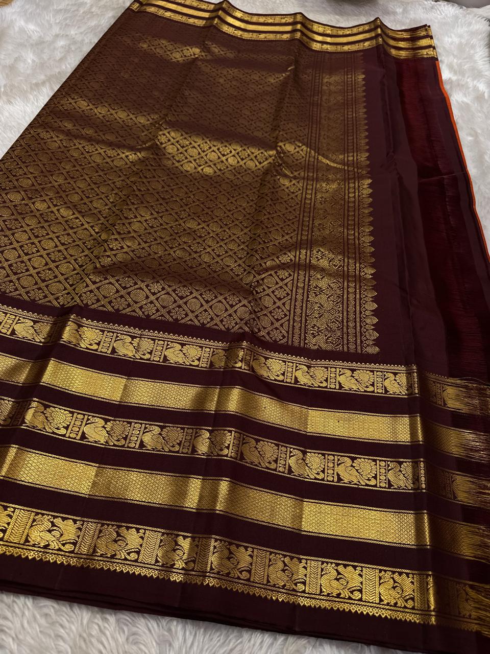 Ember Yazhi – Pure Kanchipuram Silk Saree
Burnt Orange Body with Vaira Oosi Stripes & Yazhi Buttas
Contrast Maroon Varisaipet Border with Gold Zari Panels
Grand Maroon Brocade Pallu with Intricate Motifs

Silk Mark Certified, delivery in 2 weeks