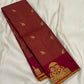 Maroon zari kattam silk saree folded lengthwise, showing gold elephant motifs and wine border with gold zari design.