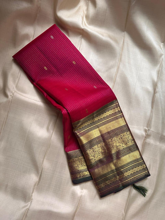 Red pure silk Kanchipuram with vertical zari stripes parrot motif varisaipet border with shot of green red Pallu