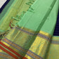 A striking blend of tradition and bold design, this navy blue Kanchipuram silk saree features delicate grid-like checks across the body. What sets it apart is the vibrant mint green and gold zari border, intricately woven with paisley and floral motifs